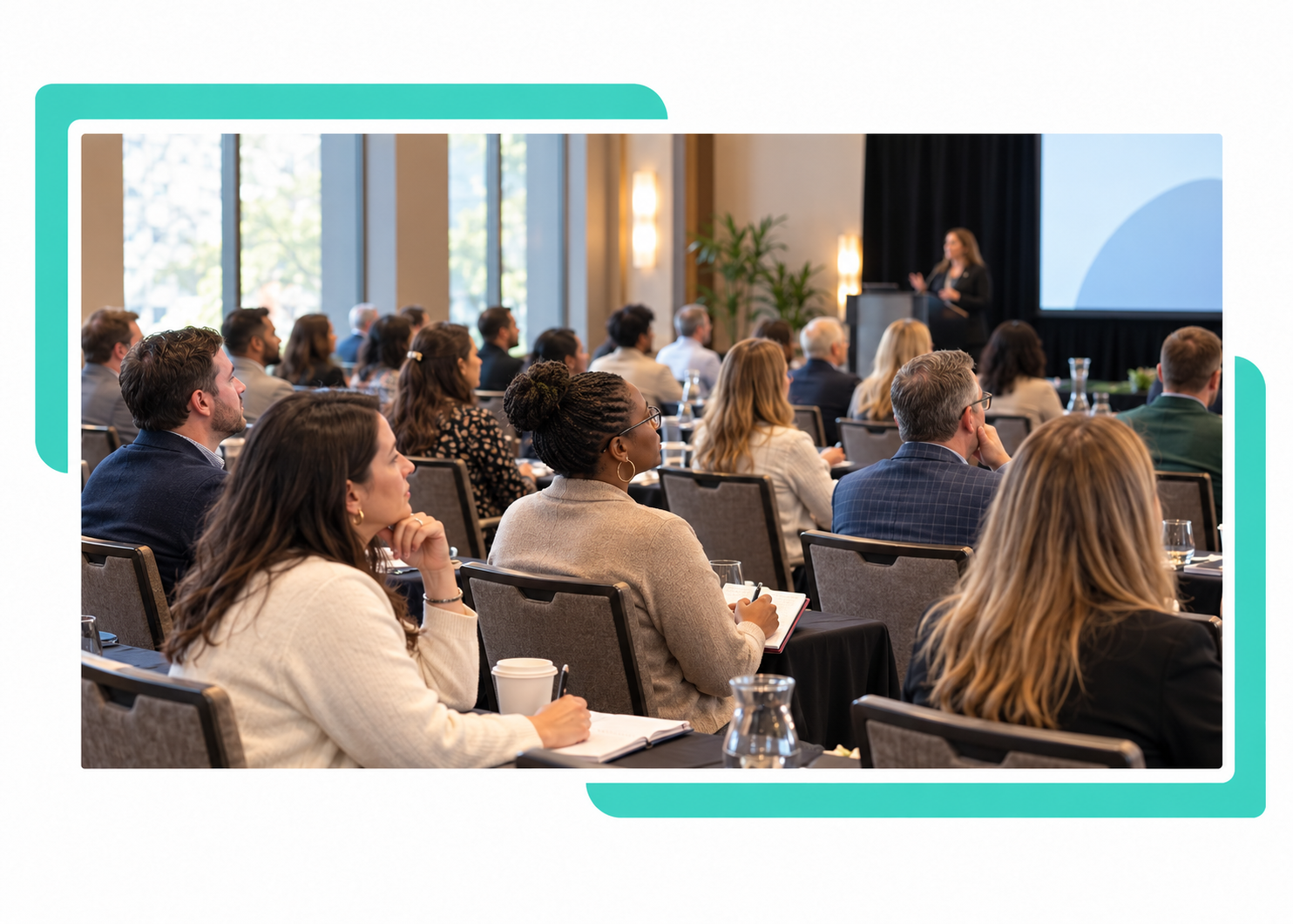 Teal-framed HR conference audience Teal-framed HR conference audience